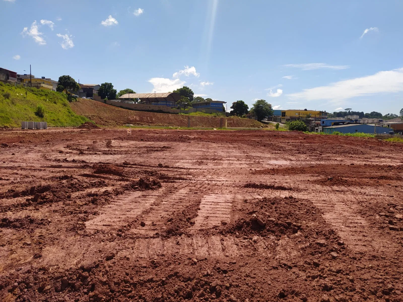 Vista aérea de campo esportivo em fase de preparação de base e drenagem